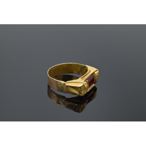 242 - High carat gold ring (22ct +) set with a red stone. 4.7 grams gross weight. UK size V/W.