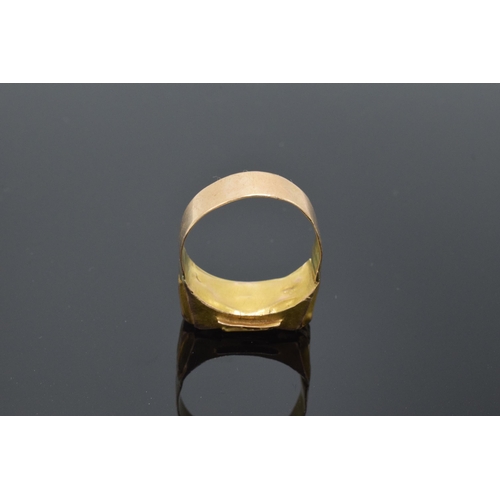 242 - High carat gold ring (22ct +) set with a red stone. 4.7 grams gross weight. UK size V/W.