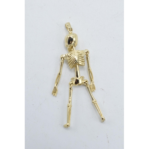 248 - 9ct gold pendant in the form of an anatomical skeleton. 2.4 grams. 4.5cm tall.