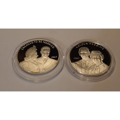 32 - A pair of sterling silver proof-like coins to include Engaged to be Married and Golden Wedding, in g... 