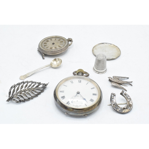 70 - A collection of silver items to include continental pocket watch, silver thimble, brooches, small sp... 