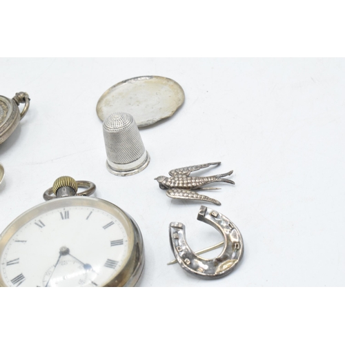 70 - A collection of silver items to include continental pocket watch, silver thimble, brooches, small sp... 