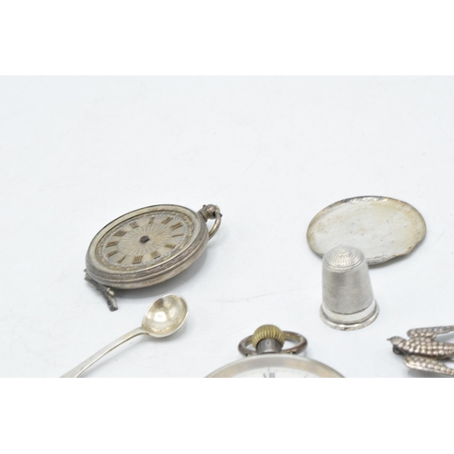 70 - A collection of silver items to include continental pocket watch, silver thimble, brooches, small sp... 