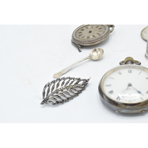 70 - A collection of silver items to include continental pocket watch, silver thimble, brooches, small sp... 