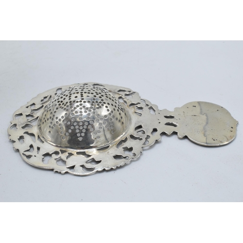 93 - Antique hallmarked silver tea strainer and silver topped collecting glass.