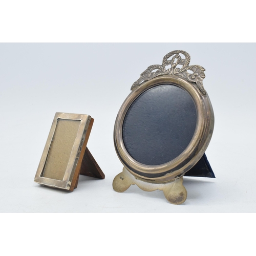 94 - A pair of small hallmarked silver photo frames, one being Birmingham 1917 / 1942 and the more ornate... 