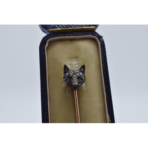 232 - Diamond and ruby set fox head stick pin with 9ct gold pin, 6.5cm long.