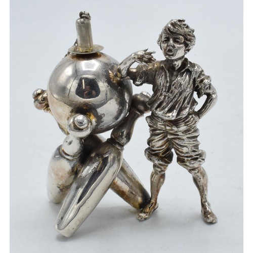 98 - Novelty silver plated table lighter in the form of a boy with bowling equipment, 9.5cm tall.