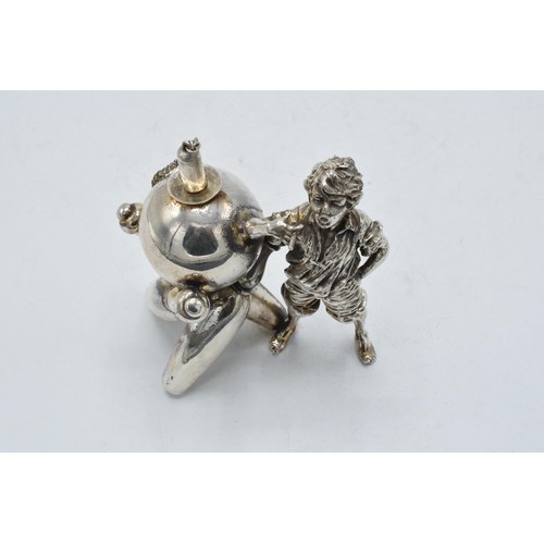 98 - Novelty silver plated table lighter in the form of a boy with bowling equipment, 9.5cm tall.