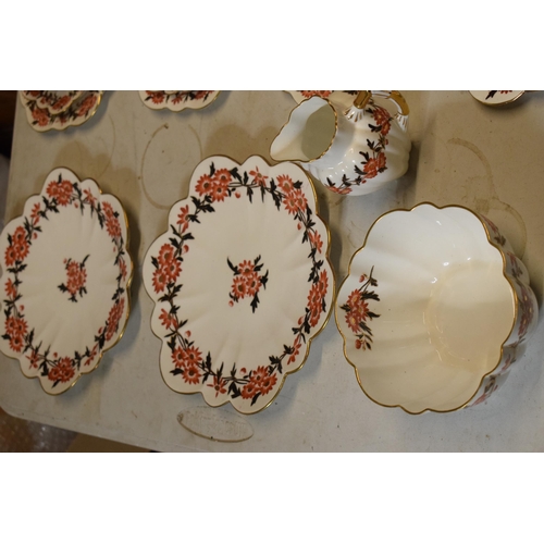 39 - A collection of Wileman & Co (Foley / Shelley) china tea ware in a red and black floral pattern, num... 