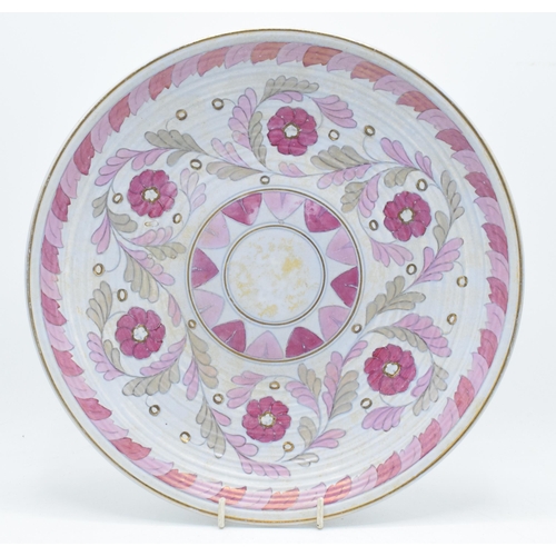 73 - Crown Ducal Charlotte Rhead charger with foliage in pink and purple colours with gilding, 32cm diame... 