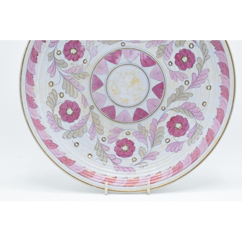 73 - Crown Ducal Charlotte Rhead charger with foliage in pink and purple colours with gilding, 32cm diame... 