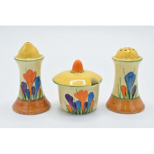 83 - Bizarre by Clarice Cliff 'Crocus' design cruet set to include salt, pepper and a sauce pot (3).