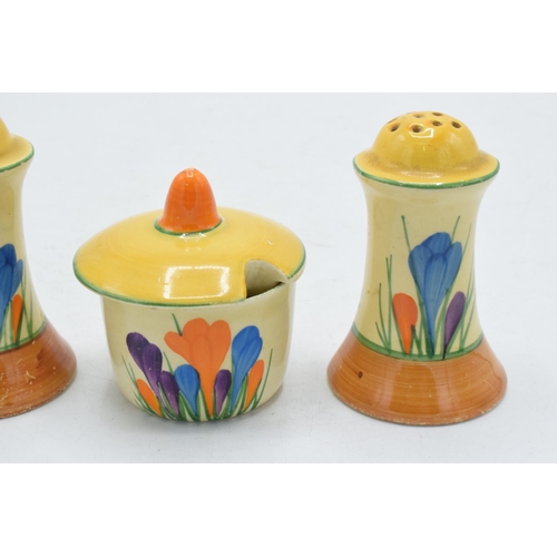 83 - Bizarre by Clarice Cliff 'Crocus' design cruet set to include salt, pepper and a sauce pot (3).