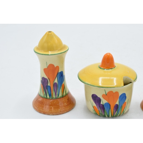 83 - Bizarre by Clarice Cliff 'Crocus' design cruet set to include salt, pepper and a sauce pot (3).