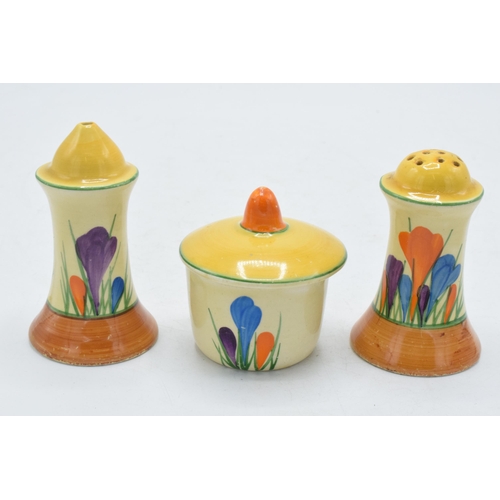 83 - Bizarre by Clarice Cliff 'Crocus' design cruet set to include salt, pepper and a sauce pot (3).