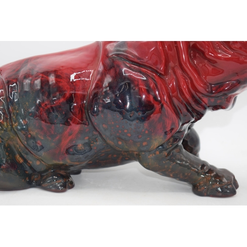 118 - Large Royal Doulton veined flambe model of a seated rhino, 42cm long.