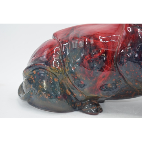 118 - Large Royal Doulton veined flambe model of a seated rhino, 42cm long.