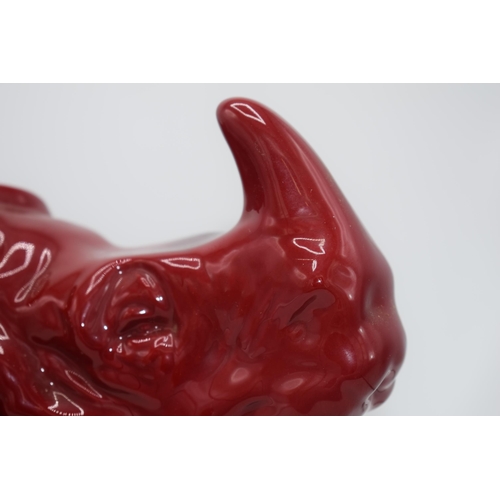 118 - Large Royal Doulton veined flambe model of a seated rhino, 42cm long.