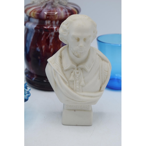 142 - A collection of items to include a Hewitt Brothers Parian bust of Shakespeare, blue glass ware and a... 