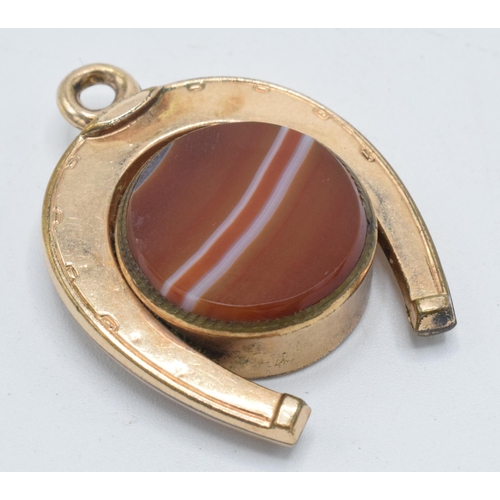 178 - Gold plated horseshoe watch fob with agate face and compass, 3.5cm long.