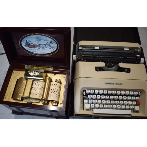 318 - Cased Olivetti Lettera 35 vintage typewriter and a modern decorative music box (2).