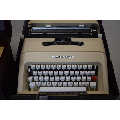 318 - Cased Olivetti Lettera 35 vintage typewriter and a modern decorative music box (2).