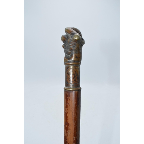 322A - Unusual malacquer (or similar) walking cane with bronze moulded putti handle, 87cm long.