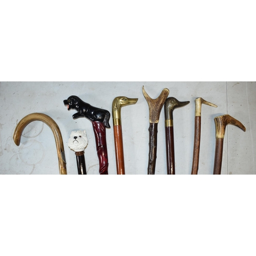 324 - A collection of vintage and similar walking sticks, some with ornate handles such as a terrier, horn... 