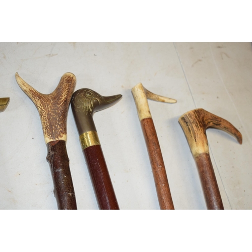 324 - A collection of vintage and similar walking sticks, some with ornate handles such as a terrier, horn... 