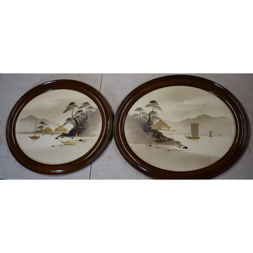 325 - A pair of 20th century mahogany framed oriental pictures of ships sailing on water amongst mountains... 