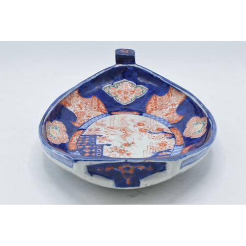 328 - 19th century Imari pottery dish in the form of a shallow boat with traditional scenes, 32cm long.