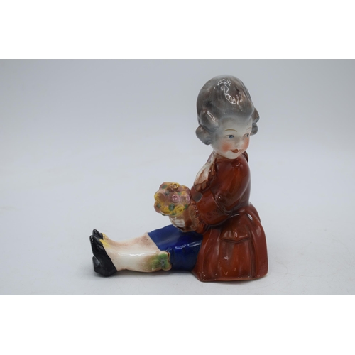 35 - A pair of early Hummel / Goebel bookends of seated girls, one holding a fan, the other flowers, look... 