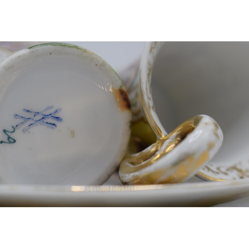 37 - A pair of continental cups and saucers with gilt decoration with Roman scenes together with a 20th c... 