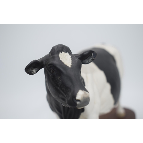 73 - Beswick Friesian Cow Connoisseur model on wooden base A2607 (left ear chipped).