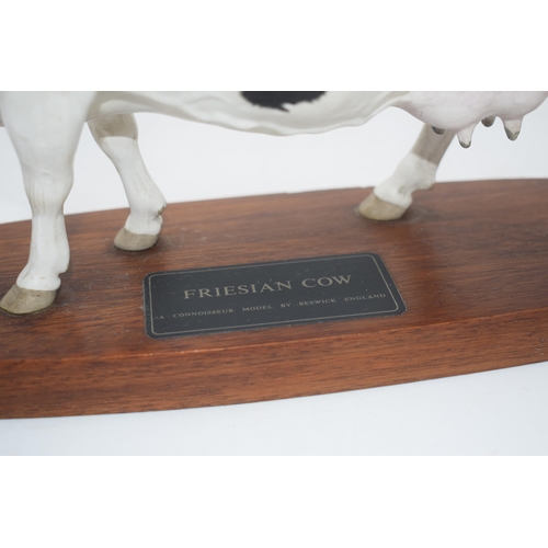 73 - Beswick Friesian Cow Connoisseur model on wooden base A2607 (left ear chipped).