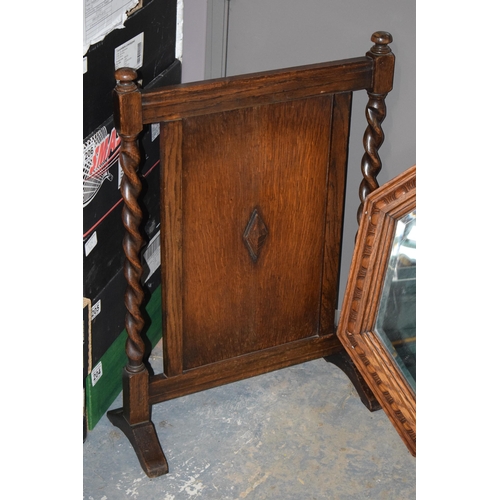 399 - 1930s octagonal oak carved mirror, 63cm diameter, together with a similar fire screen, 72cm tall (2)... 