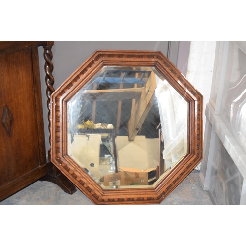 399 - 1930s octagonal oak carved mirror, 63cm diameter, together with a similar fire screen, 72cm tall (2)... 