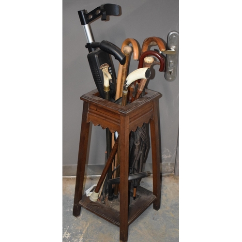 400 - 1930s wooden hall stick stand together with a range of walking sticks, to include country interest, ... 