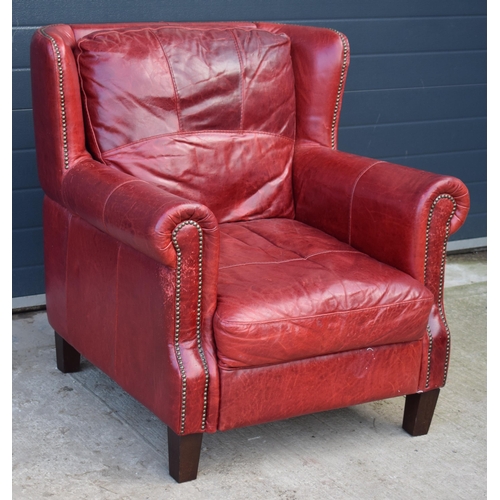 401 - Red leather chesterfield-style leather high-backed arm chair with beaded design, 90x90x97cm tall.