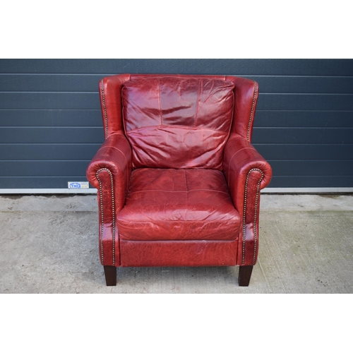 401 - Red leather chesterfield-style leather high-backed arm chair with beaded design, 90x90x97cm tall.