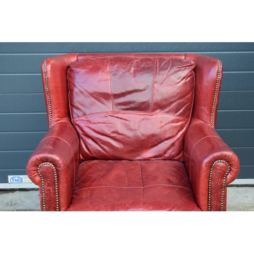 401 - Red leather chesterfield-style leather high-backed arm chair with beaded design, 90x90x97cm tall.