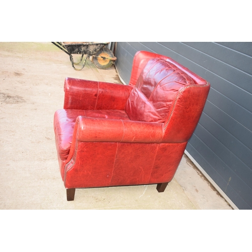 401 - Red leather chesterfield-style leather high-backed arm chair with beaded design, 90x90x97cm tall.