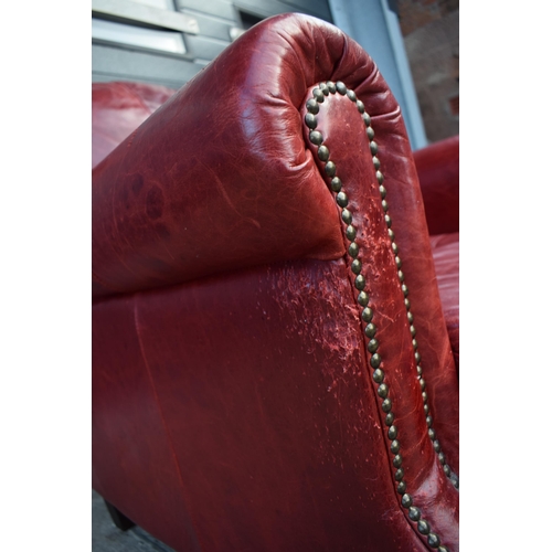 401 - Red leather chesterfield-style leather high-backed arm chair with beaded design, 90x90x97cm tall.