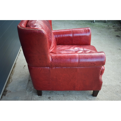 401 - Red leather chesterfield-style leather high-backed arm chair with beaded design, 90x90x97cm tall.