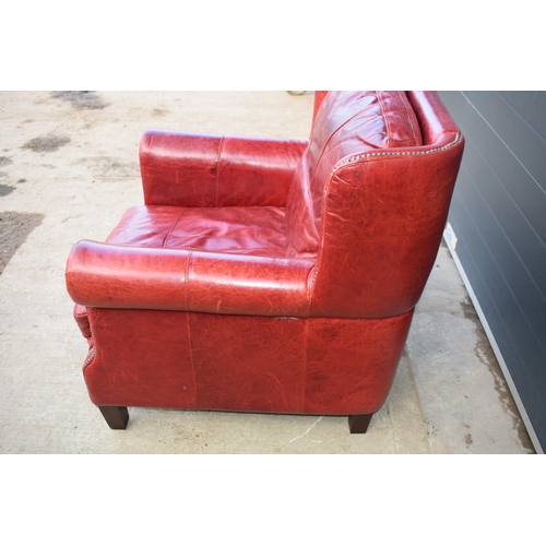 401 - Red leather chesterfield-style leather high-backed arm chair with beaded design, 90x90x97cm tall.