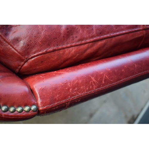 401 - Red leather chesterfield-style leather high-backed arm chair with beaded design, 90x90x97cm tall.