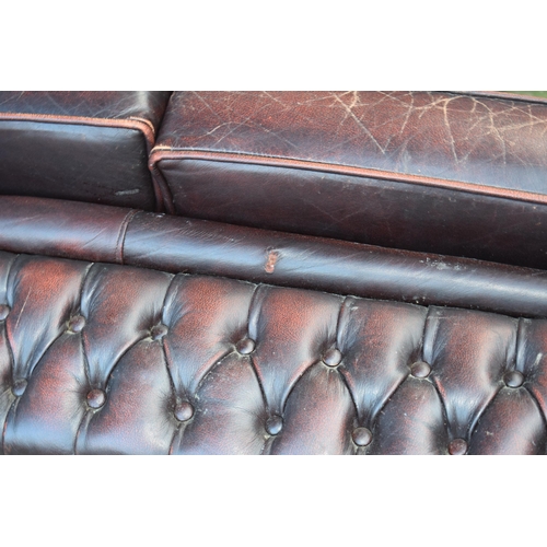 402 - Brown leather Chesterfield-style high-backed 2 seater club sofa with button-back design, 143x90x95cm... 