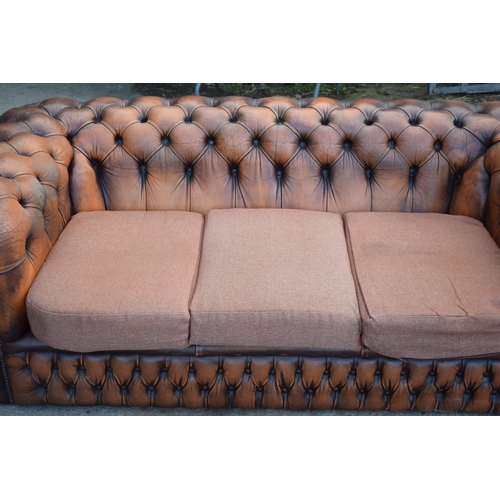 403 - Brown leather deep buttoned Chesterfield three seater sofa with metal beading, 192x98x65cm tall, cus... 