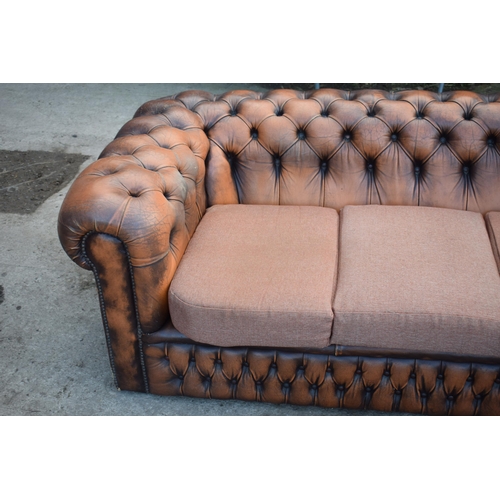 403 - Brown leather deep buttoned Chesterfield three seater sofa with metal beading, 192x98x65cm tall, cus... 